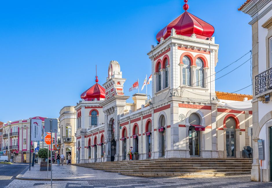 Stunning view of the iconic Loulé Market with distinct Moorish architecture under a bright blue sky.
