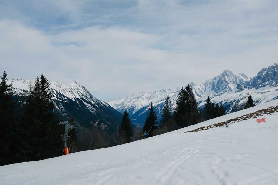 Scenic view of snow-covered mountains and pine trees in a winter alpine landscape, perfect for skiing.