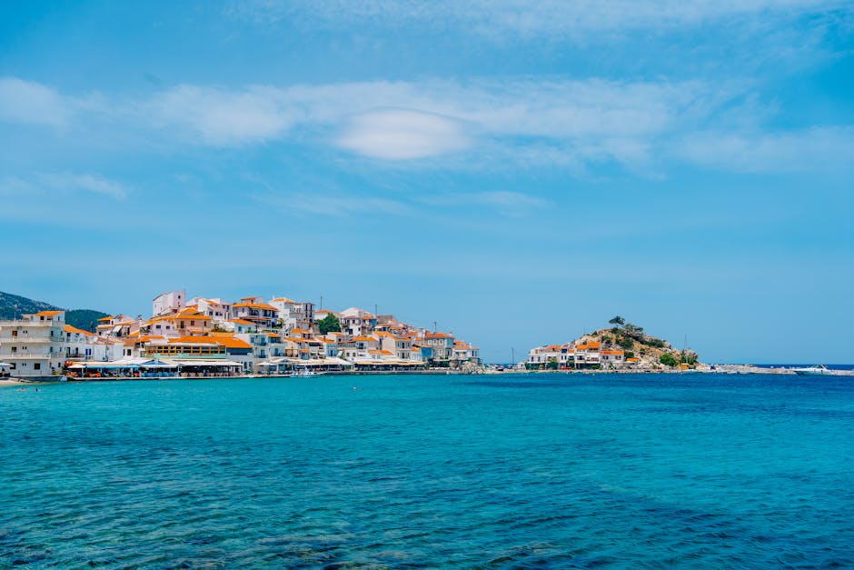 Picturesque coastal village with turquoise waters and charming houses on a sunny Mediterranean island.
