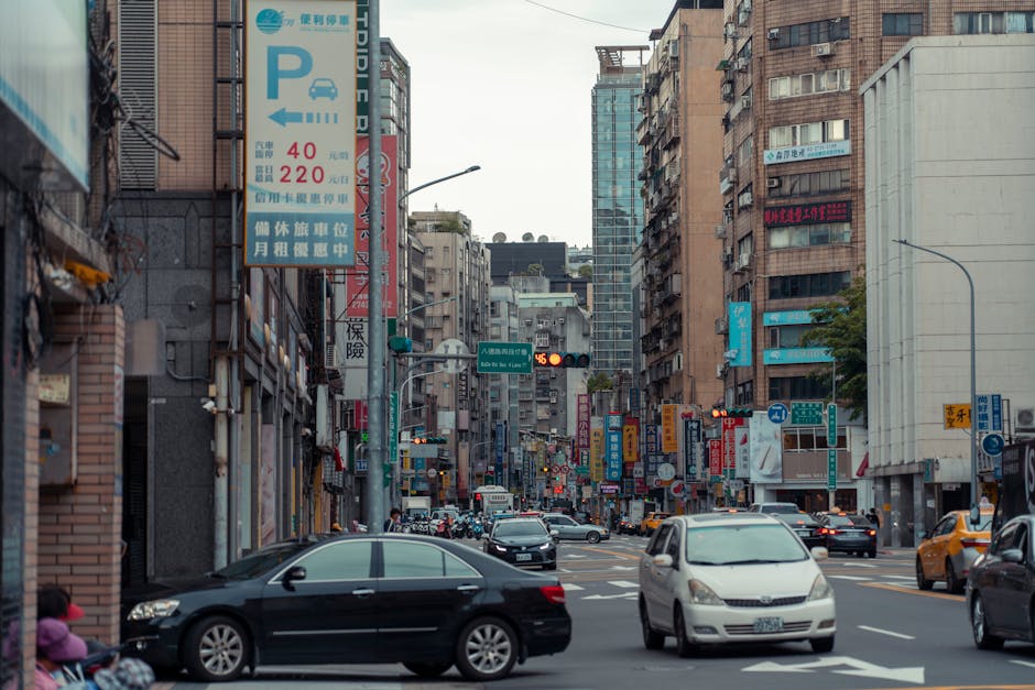 An everyday cityscape of Taipei highlighting urban life, traffic, and architecture.