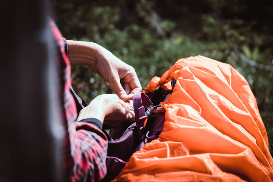 Hands adjusting outdoor equipment during a hiking trip.
