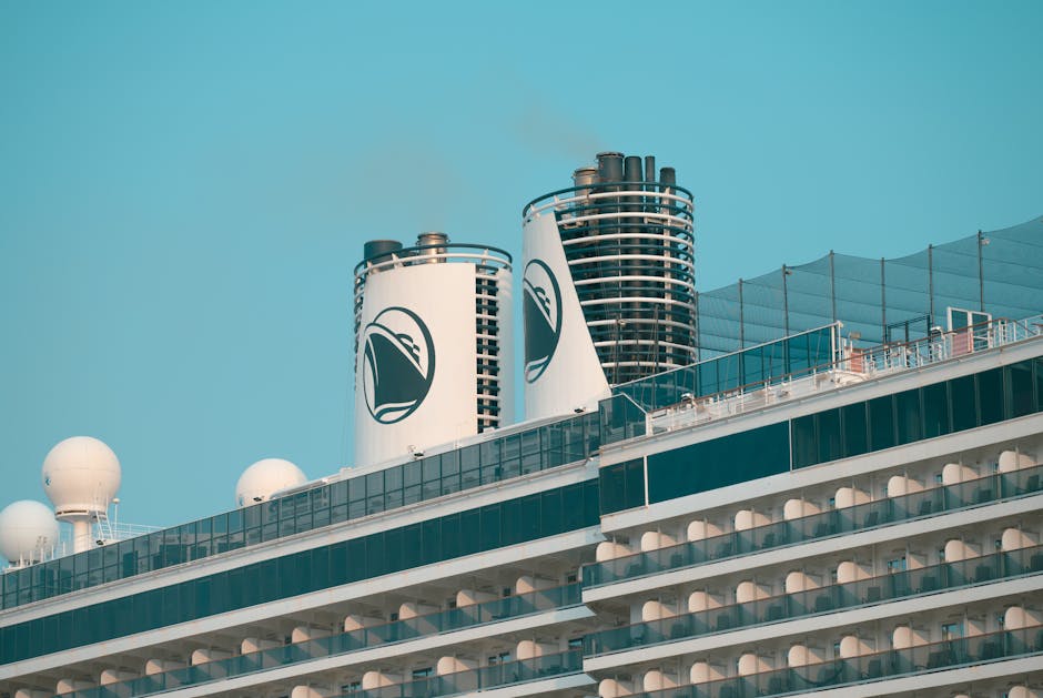 Close-up of cruise ship chimneys with a clear blue sky, showcasing modern maritime design.