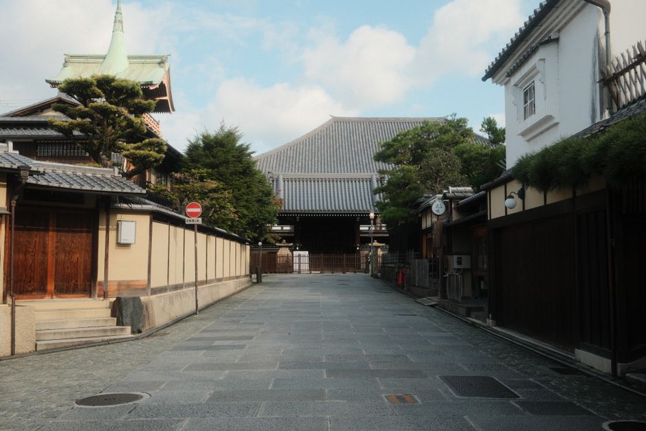 Serene street view in Kyoto, Japan, featuring traditional architecture leading to a historic temple.