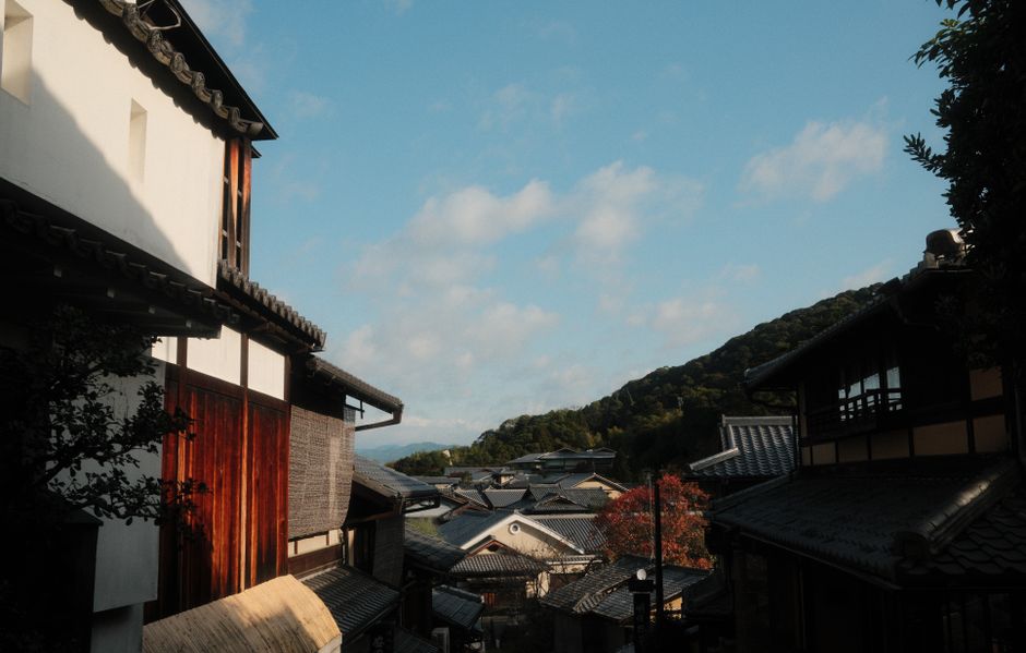 Charming view of traditional Kyoto architecture under a blue sky, emphasizing cultural heritage.