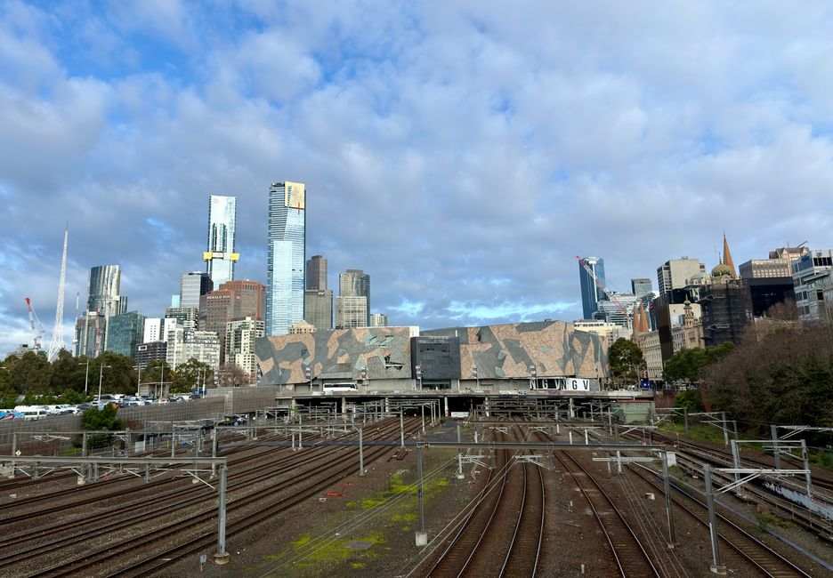 Skyline of Melbourne, Victoria featuring railway tracks and NGV on a clear day.