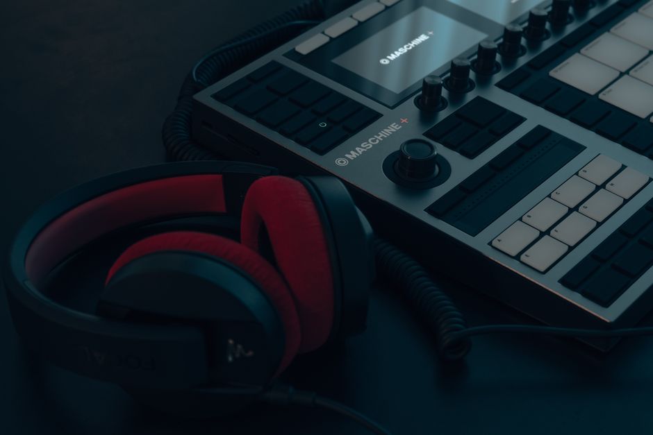 A detailed shot of a drum machine and headphones, essential audio equipment.
