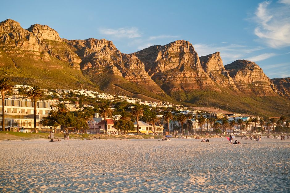 Beautiful sunset view of Camps Bay Beach with the Twelve Apostles in the background, Cape Town.