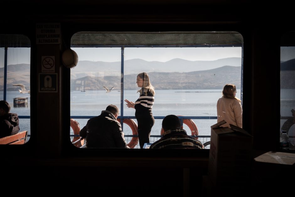 View from ferry interior showing passengers enjoying a scenic ride on the lake.