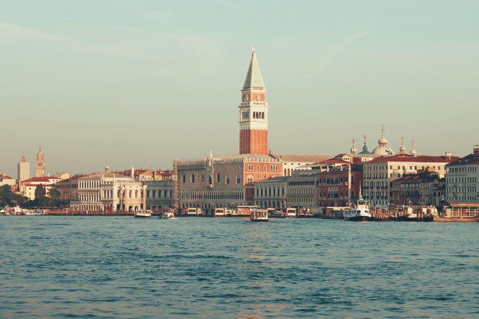 Captivating view of St. Mark's Campanile and Venice waterfront at sunset, showcasing historic architecture.